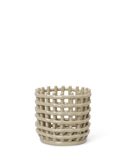 Beige woven ceramic basket on a white background