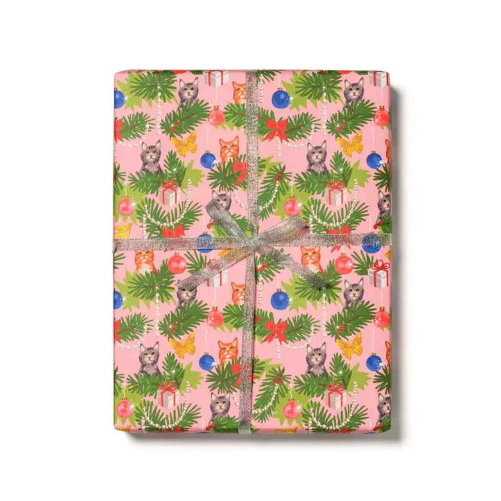 A wrapped gift with multicolored stripes and floral patterned wrapping paper, tied with a green ribbon.