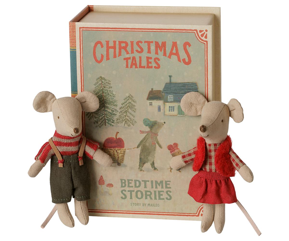two stuffed animal mice in front of book shaped box that reads "christmas tales bedtime stories by maileg"
