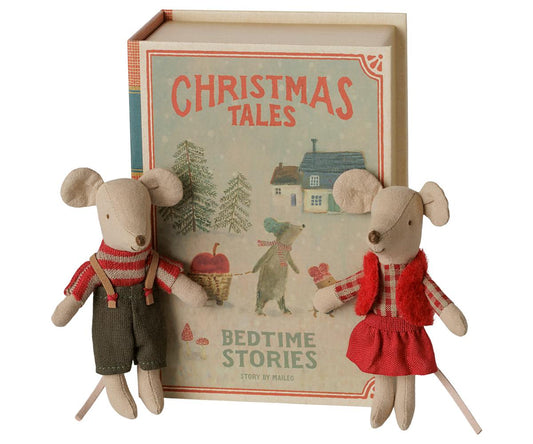 two stuffed animal mice in front of book shaped box that reads "christmas tales bedtime stories by maileg"