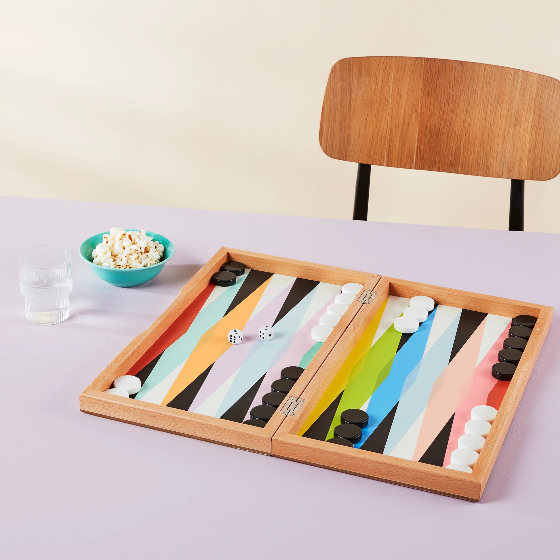 Colorful designed Backgammon set with black and white board game pieces. Games found at Huset Shop in Venice California. Scandinavian Design and joyful pastime and shopping.