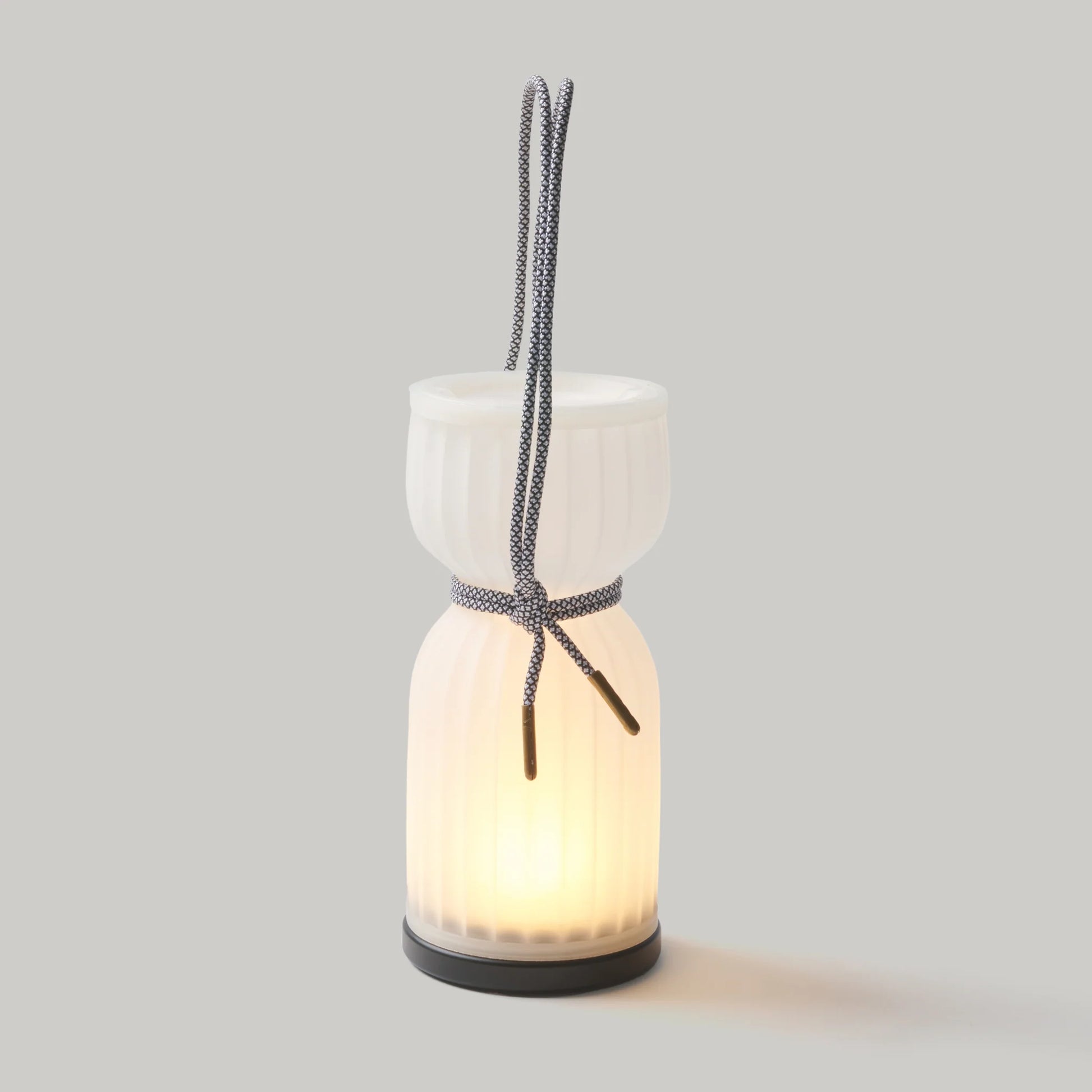 Initially inspired by the shape of water gourds and sake bottles, the Camp Lantern features a playful paracord sling handle, meant to encourage and highlight portability – hang it on a bedpost, take it on a picnic, or simply carry it with you around the house.&nbsp;
Cordless unit is USB-C rechargeable, features three dim-to-warm brightness settings, and lasts for up to 80 hours between charges.