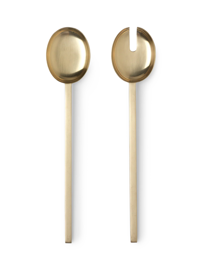 Two gold-colored spoons on a white background
