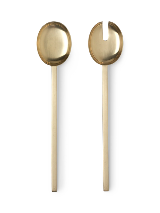 Two gold-colored spoons on a white background