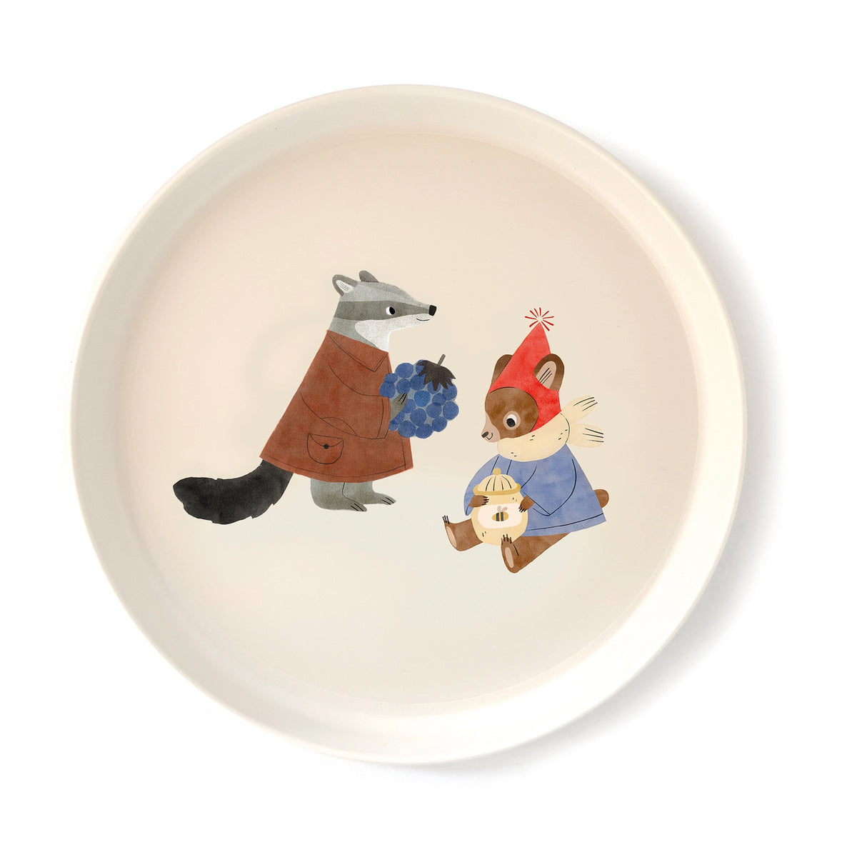 A round off-white ceramic plate featuring a whimsical illustration of a gray raccoon in a brown coat holding blue grapes next to a brown squirrel wearing a red hat and blue coat holding a bagel.