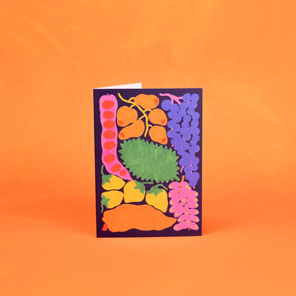 Colorful card with fruit illustrations on an orange background. This card supports animals and the Amazon rainforest.