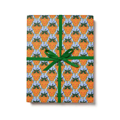 A wrapped gift with multicolored stripes and floral patterned wrapping paper, tied with a green ribbon.