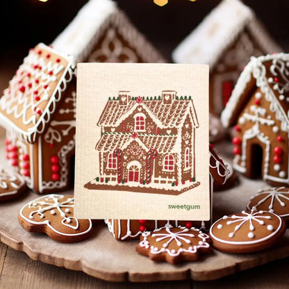 Gingerbread house swedish dishcloth with gingerbread cookies on a wooden surface