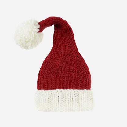 Red and white knitted Santa hat with a pom-pom on a white background