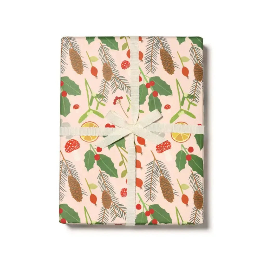 A wrapped gift with multicolored stripes and floral patterned wrapping paper, tied with a green ribbon.