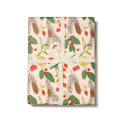 A wrapped gift with multicolored stripes and floral patterned wrapping paper, tied with a green ribbon.