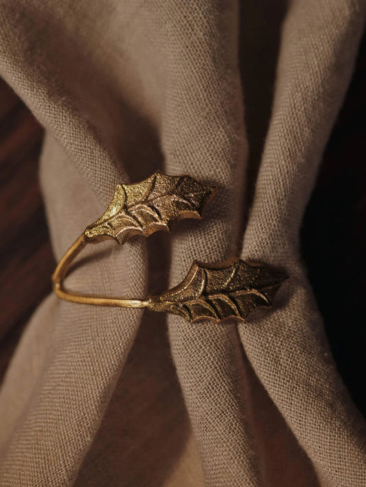 Inspired by nature, the Holly Leaf Napkin Rings echo the elegance of fine jewellery, lending a graceful and effortless accent to the holiday table. Crafted from cast brass, each ring features intricate detailing that reflects the organic beauty of holly leaves. Designed to wrap delicately around your napkins, they bring a sense of occasion to festive gatherings and meaningful moments alike.