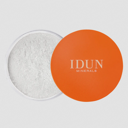 IDUN Minerals Loose Mattifying Powder, with the product container open, showing the white powder inside and the brand's logo on the orange lid.
