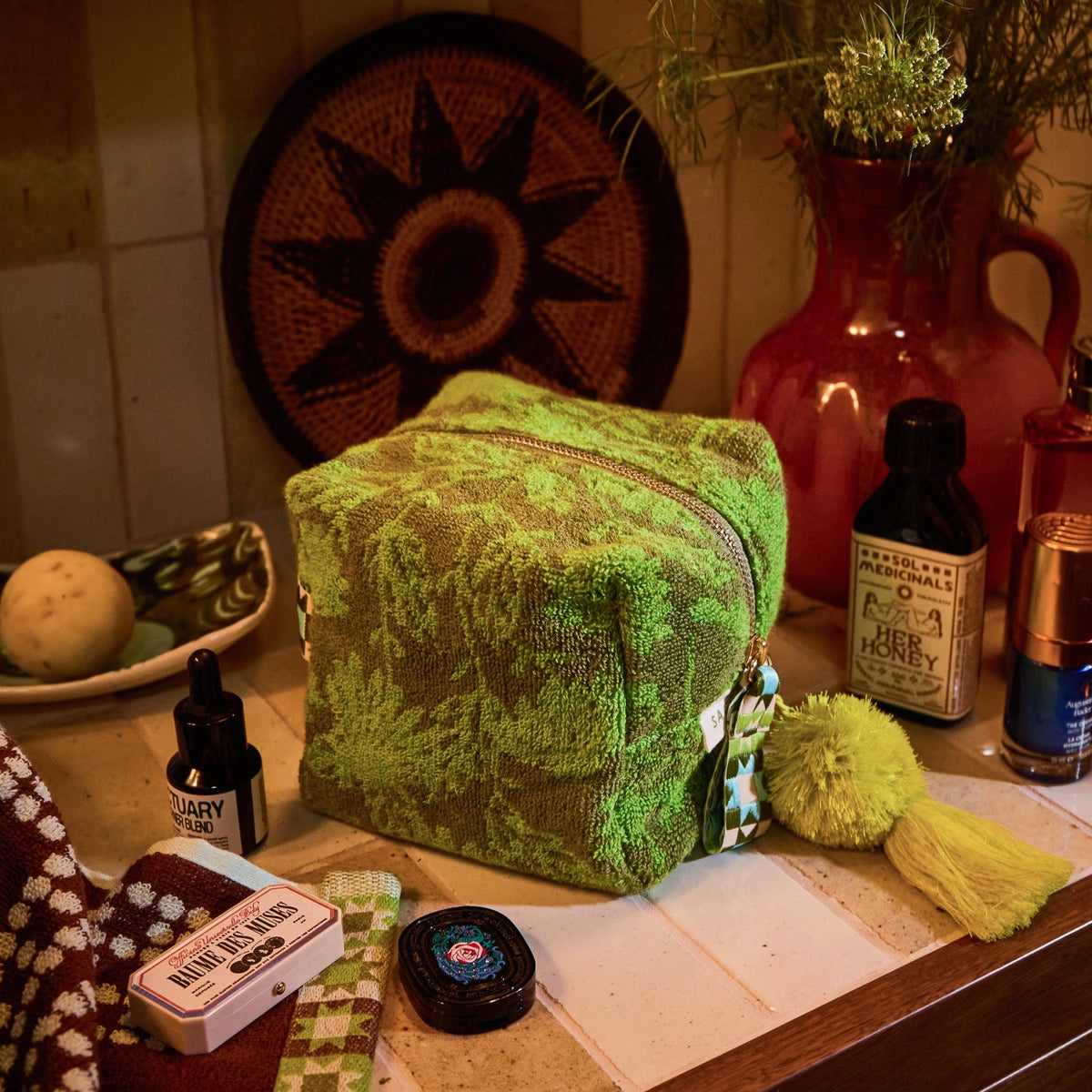 Green pouch in warm toned bathroom counter
