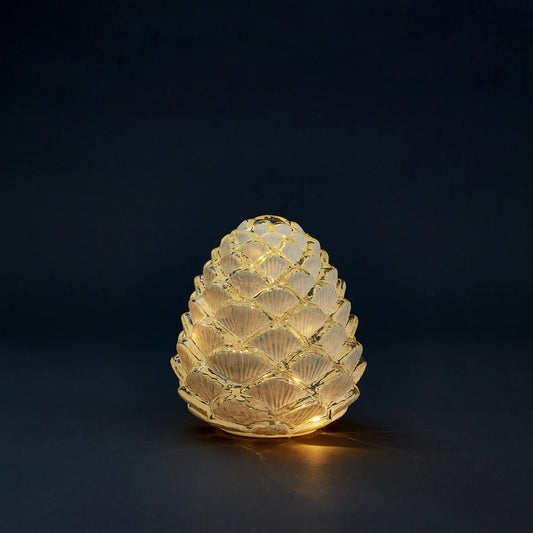 Decorative frosted glass pinecone light that uses batteries and lights up for a beautiful cozy ambiance in any space. Perfect for the holiday season and placing on a tablescape or on a mantel. 