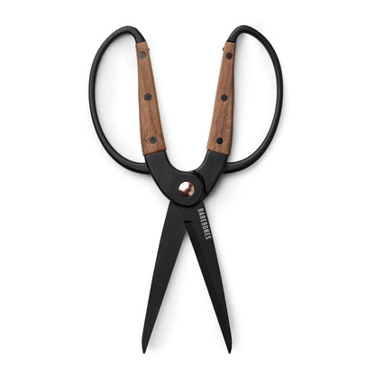 Black shears with wooden handles on a white background