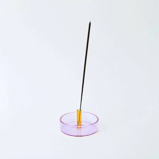 Purple with Yellow glass going up the middle holding an incense stick on a white background 