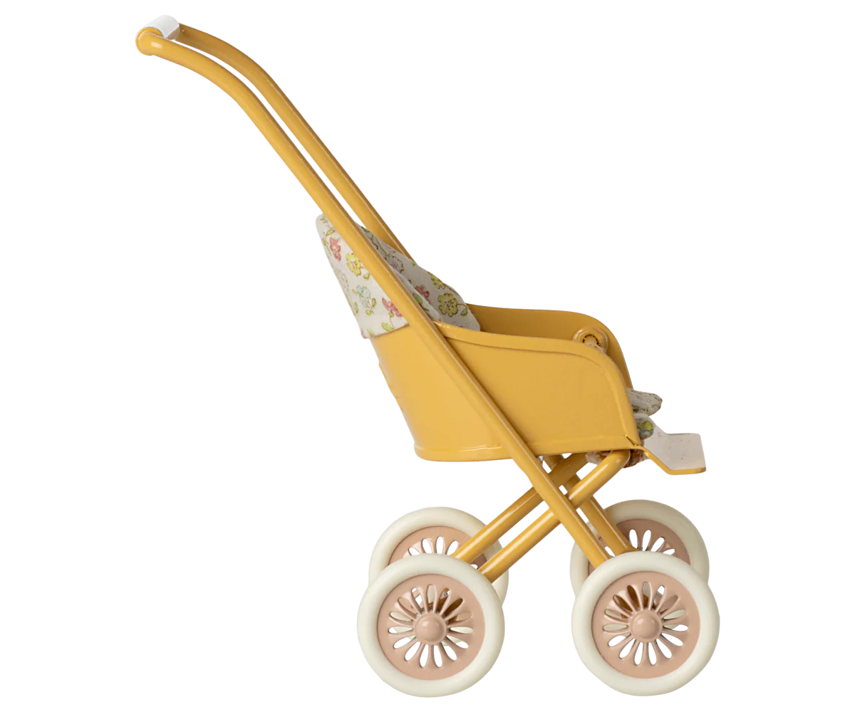 Yellow toy stroller with floral pattern on a white background
