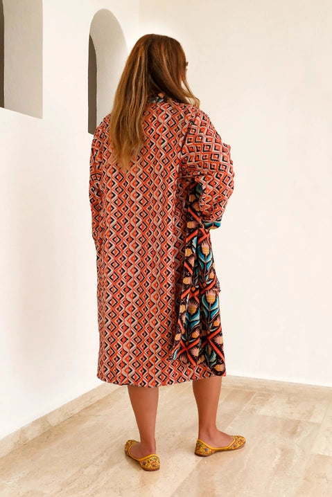 This duster coat is pure luxury, crafted of silky plush cotton velvet and smooth woven cotton on the reverse. We call this a duster because it can be worn as a robe or a coat--it even has pockets on both sides! This coat features a signature Handker hand-drawn pattern and is a cuddly hug no matter how you wear it.