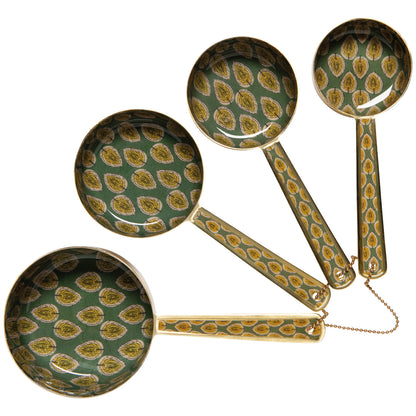 Set of decorative spoons with green and gold pattern on a white background