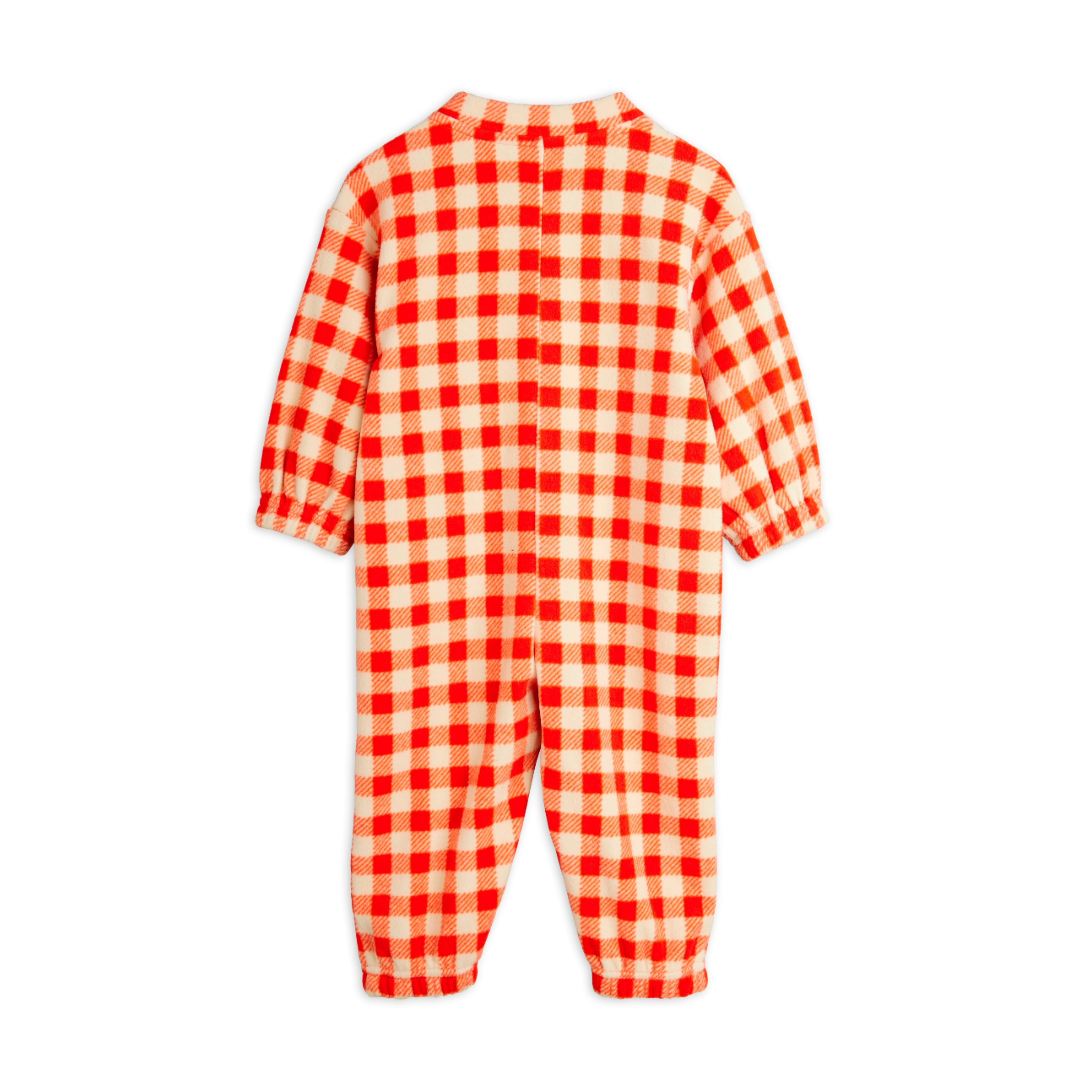 Red and white checkered baby onesie on a white background, Keep your little one cozy and cute in the Mini Rodini Gingham Fleece Overall! This soft, warm fleece features a charming gingham pattern that adds a playful touch to chilly days. Perfect for adventures indoors or out, it’s designed to keep your child snug while looking absolutely adorable. Easy to wear and easy to love!