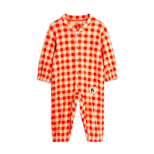 Red and white checkered baby onesie on a white background. Keep your little one cozy and cute in the Mini Rodini Gingham Fleece Overall! This soft, warm fleece features a charming gingham pattern that adds a playful touch to chilly days. Perfect for adventures indoors or out, it’s designed to keep your child snug while looking absolutely adorable. Easy to wear and easy to love!