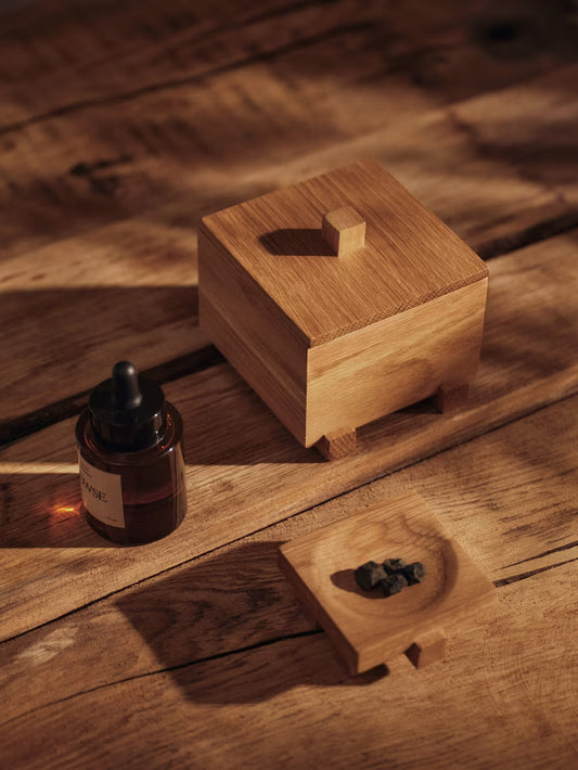 Store your most treasured small items in the Moku Box, an FSC™-certified solid oak box set on elevated, beam-like feet. Refined wood joinery underscores the meticulous craftsmanship and warm materiality, while the overall silhouette remains minimal. The Moku Box is well suited to a bedside table, desk, or shelf, adding a subtle visual accent.
