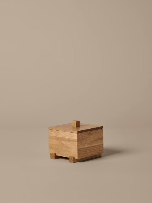 Wooden box with a lid on a beige background