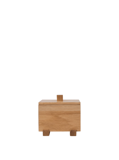 Store your most treasured small items in the Moku Box, an FSC™-certified solid oak box set on elevated, beam-like feet. Refined wood joinery underscores the meticulous craftsmanship and warm materiality, while the overall silhouette remains minimal. The Moku Box is well suited to a bedside table, desk, or shelf, adding a subtle visual accent.