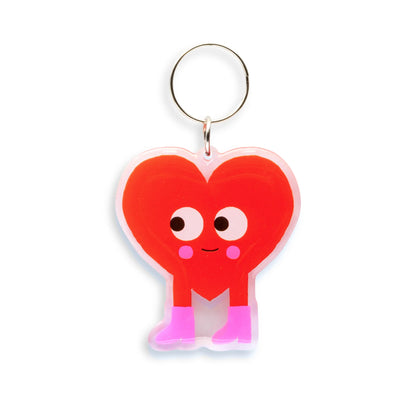 Heart-shaped keychain with a smiling face on a white background