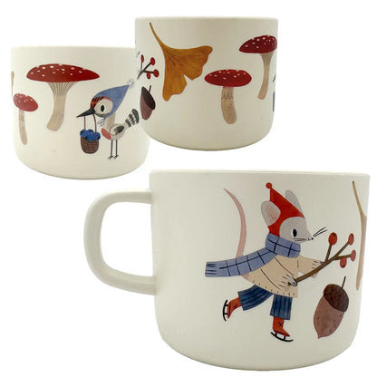 Three ceramic mugs with forest-themed illustrations on a white background