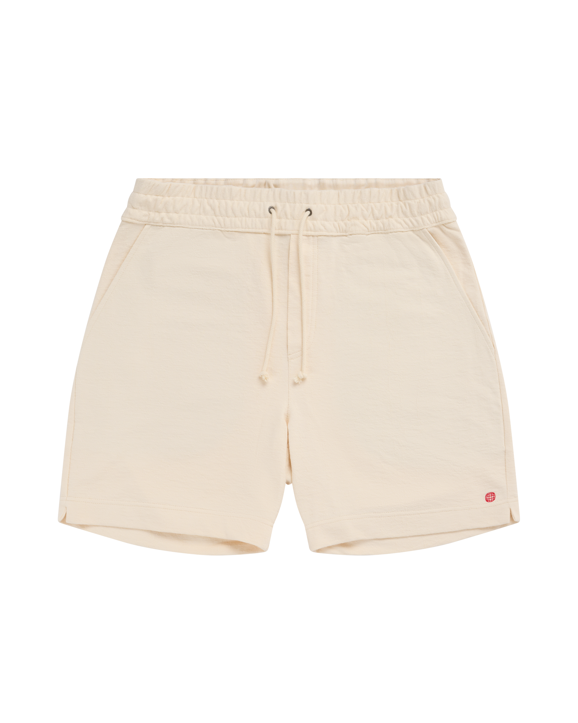 Beige shorts with a small red logo on a white background