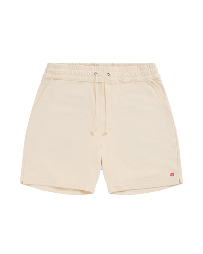 Beige shorts with a small red logo on a white background