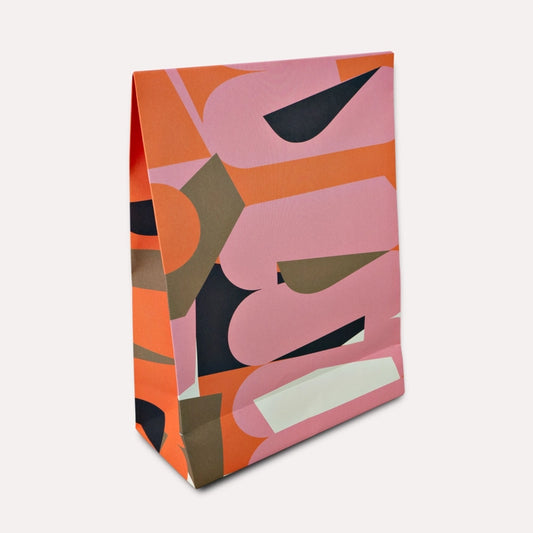 A flat gift bag that’s all edge, no filler. The Osaka print brings graphic punch and full-colour energy to your shelves—designed to stand out among the beige and boring. With a sturdy flat base and luxe paper feel, it’s the packaging equivalent of a statement outfit. Made from 120gsm FSC-certified paper and printed with soy-based inks, it’s as sustainable as it is good-looking. Ships flat for easy storage. It has double sided tape to secure the flap.&nbsp;