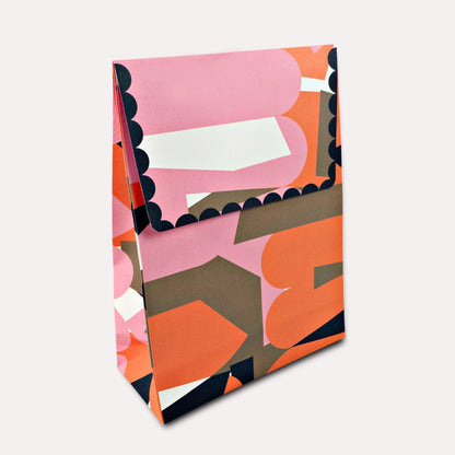 A flat gift bag that’s all edge, no filler. The Osaka print brings graphic punch and full-colour energy to your shelves—designed to stand out among the beige and boring. With a sturdy flat base and luxe paper feel, it’s the packaging equivalent of a statement outfit. Made from 120gsm FSC-certified paper and printed with soy-based inks, it’s as sustainable as it is good-looking. Ships flat for easy storage. It has double sided tape to secure the flap.&nbsp;