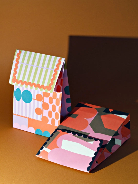 A flat gift bag that’s all edge, no filler. The Osaka print brings graphic punch and full-colour energy to your shelves—designed to stand out among the beige and boring. With a sturdy flat base and luxe paper feel, it’s the packaging equivalent of a statement outfit. Made from 120gsm FSC-certified paper and printed with soy-based inks, it’s as sustainable as it is good-looking. Ships flat for easy storage. It has double sided tape to secure the flap.&nbsp;