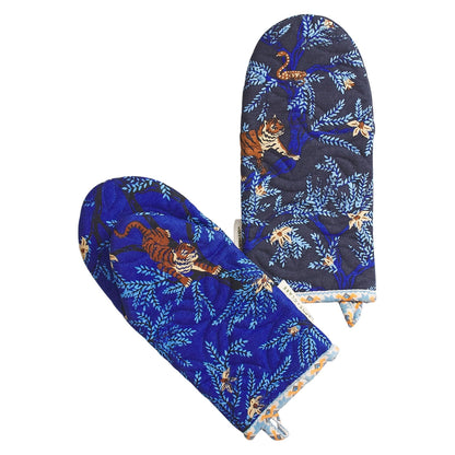 Pair of blue oven mitts with tiger design on a white background
