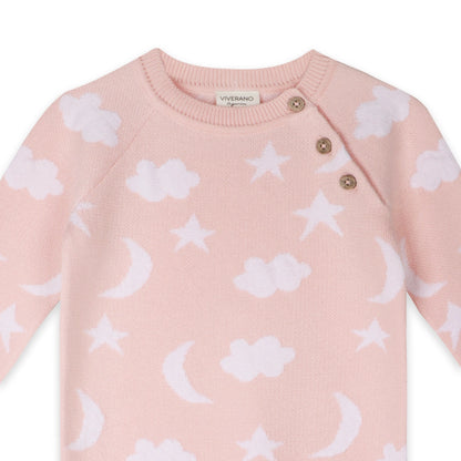 Pink baby sweater with white cloud, star, and moon patterns on a white background.