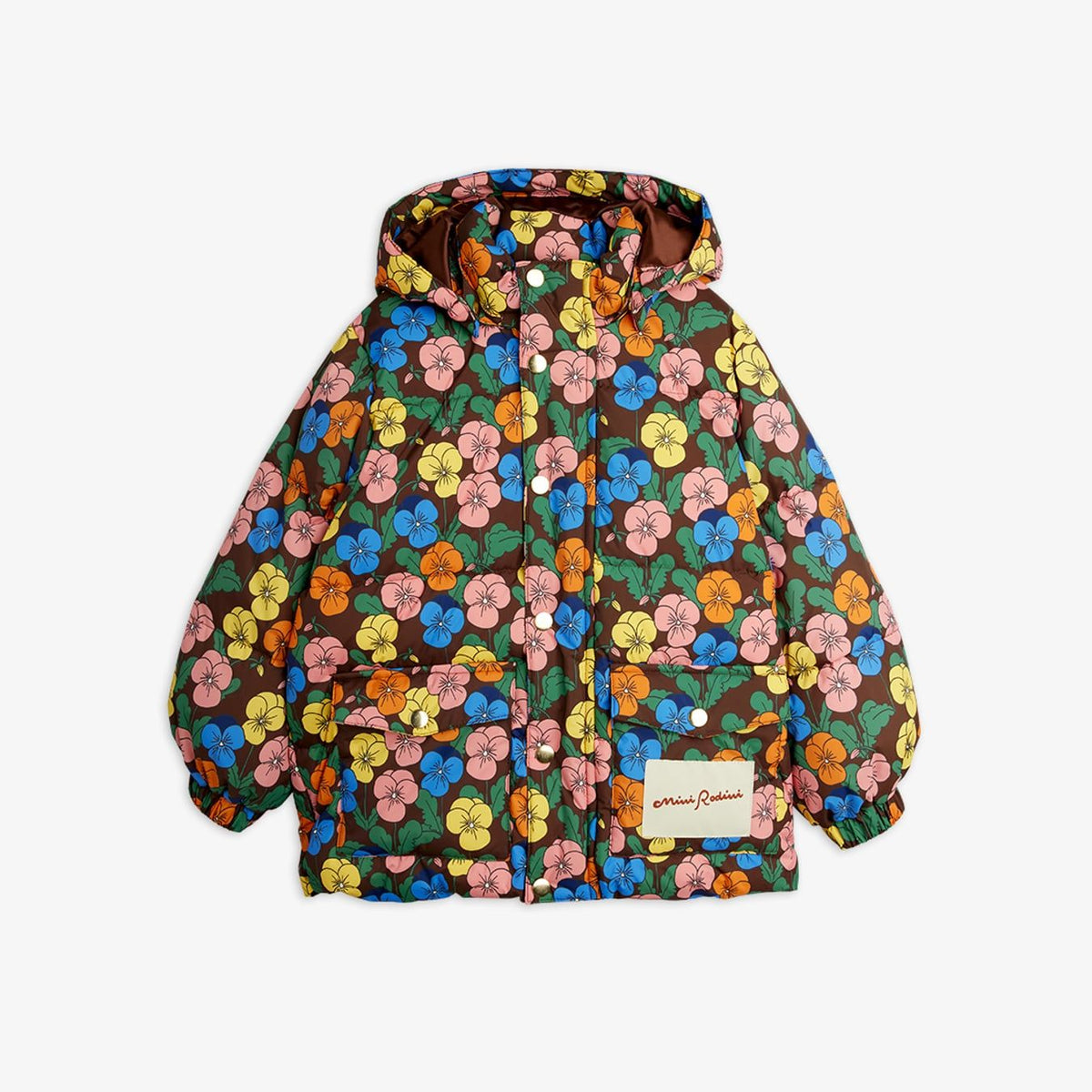 A hooded puffer jacket by James Richardson, featuring a vibrant multicolor floral print on a dark brown base. The pattern includes pink, yellow, blue, and orange flowers with green leaves.
