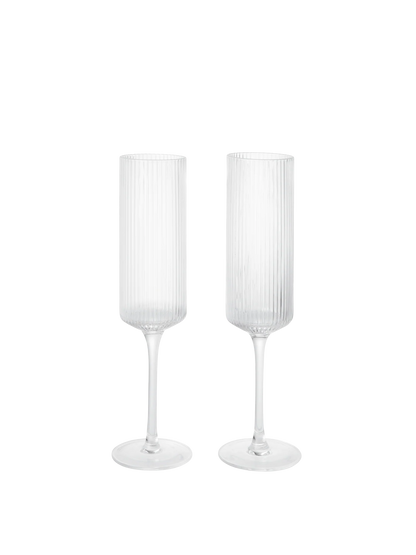 The Ripple Champagne Flutes bring a refined, elongated silhouette to the beloved Ripple series, perfectly suited for sparkling wines. Mouth-blown into the mould, each glass features the signature rippled surface that adds texture and a sense of movement. Their tall, slender shape enhances bubbles and aroma, making any toast feel celebratory.