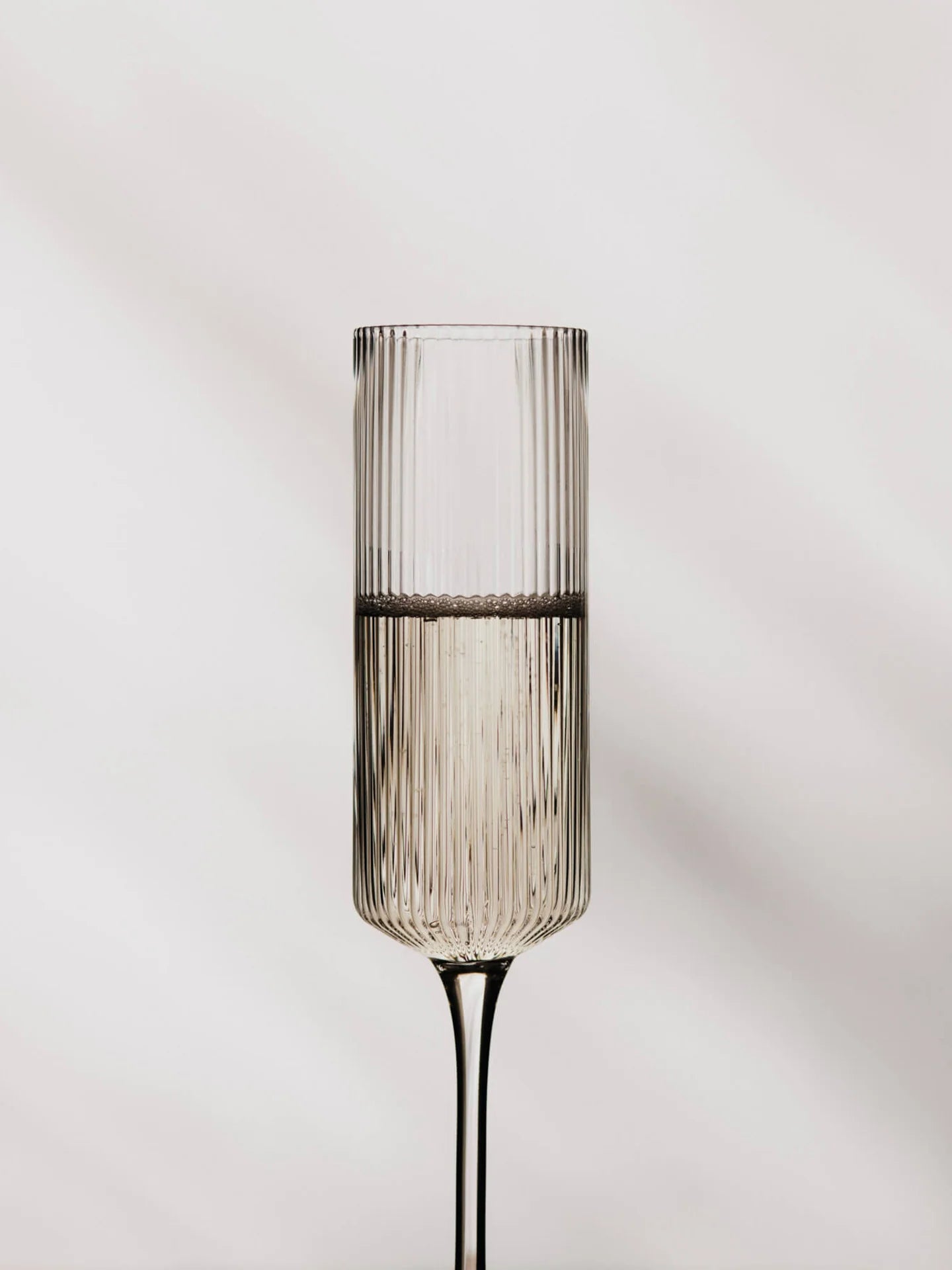 The Ripple Champagne Flutes bring a refined, elongated silhouette to the beloved Ripple series, perfectly suited for sparkling wines. Mouth-blown into the mould, each glass features the signature rippled surface that adds texture and a sense of movement. Their tall, slender shape enhances bubbles and aroma, making any toast feel celebratory.