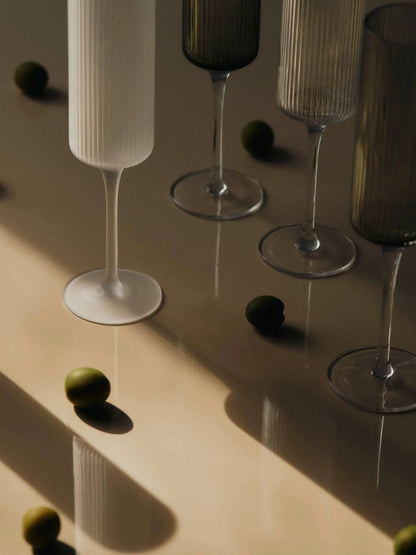 The Ripple Champagne Flutes bring a refined, elongated silhouette to the beloved Ripple series, perfectly suited for sparkling wines. Mouth-blown into the mould, each glass features the signature rippled surface that adds texture and a sense of movement. Their tall, slender shape enhances bubbles and aroma, making any toast feel celebratory.