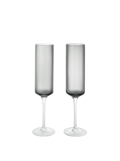 The Ripple Champagne Flutes bring a refined, elongated silhouette to the beloved Ripple series, perfectly suited for sparkling wines. Mouth-blown into the mould, each glass features the signature rippled surface that adds texture and a sense of movement. Their tall, slender shape enhances bubbles and aroma, making any toast feel celebratory.