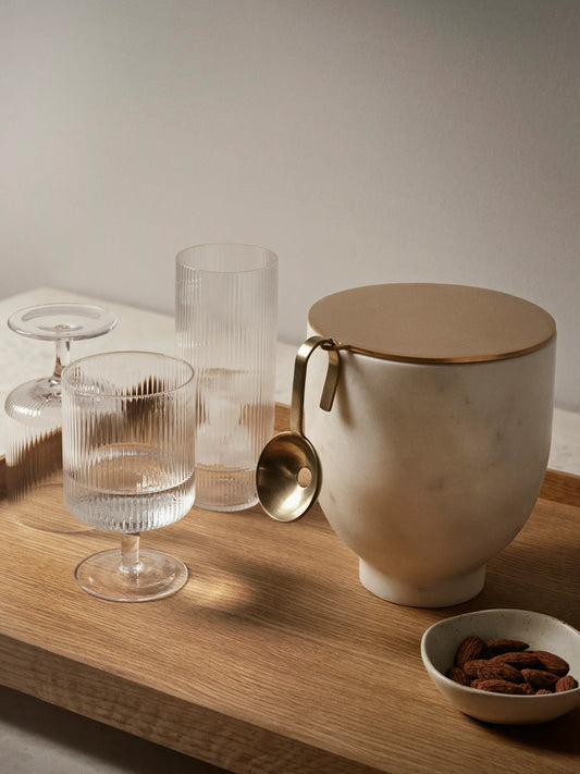 For a casual drink in the garden, the large dinner party or as the fancy supplement at brunch, the Ripple Wine Glass will complete any setting with its unique expression. Mouth-blown into the shape the wine glasses feature the series' characteristic rippled surface and geometric silhouette, making the set of two glasses stack able. Pair the glasses with the rest of the Ripple series and serve your favorite beverage in style.