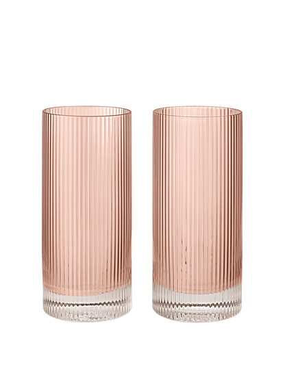 Two tall, cylindrical fluted glass tumblers with a rose glass finish and a clear ribbed glass base, shown side-by-side on a plain white background.