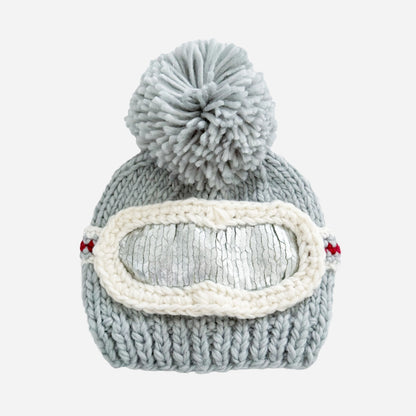 Gray knit beanie with pom-pom and goggles on a white background