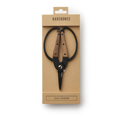 Small scissors with wooden handles in a Barebones packaging on a white background