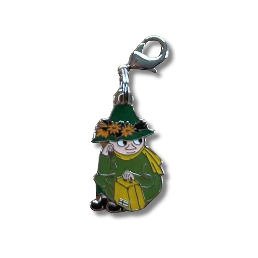 Character named Snufkin as a charm in green outfit with hat and sitting with a suitcase. Great gift for any Moomin fans