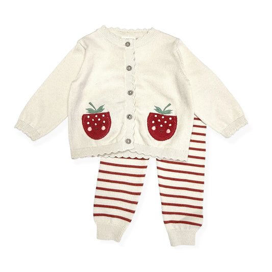 Baby outfit with cream cardigan and red striped pants on a white background