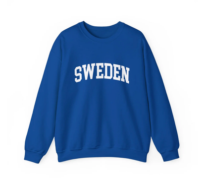 A royal blue crewneck sweatshirt with the word 'SWEDEN' printed in white arched block letters across the chest, displayed on a clean white background.